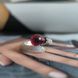 купить серебряное изделие Серебряное кольцо LoveR разомкнутое с подвесным нано-гранатом и широким паве из фианитов 17.5 размер фото 5 - фотография из каталога